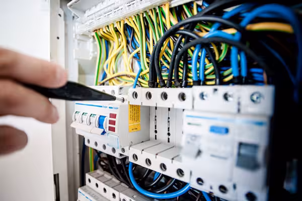 Professional electrician performing switchboard upgrade for home safety